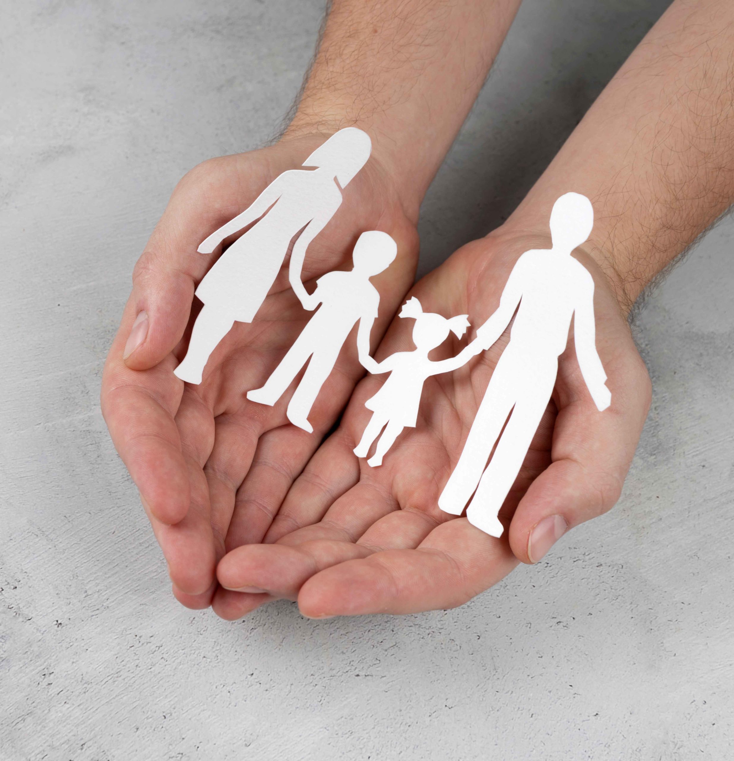 close-up-hands-holding-paper-family